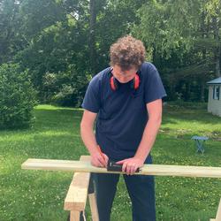 Henry measuring a board on site