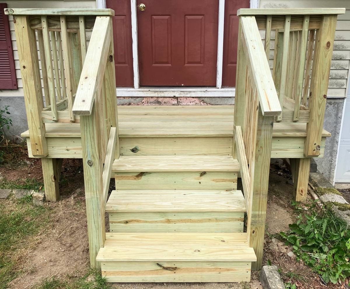 Close-up of newly built wooden entry steps, landing, and railings
