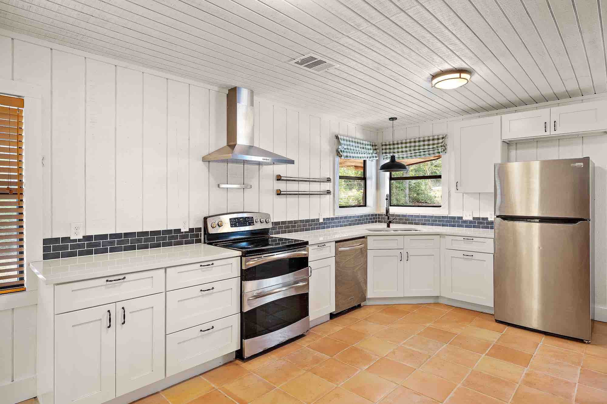 After: bright white kitchen with Saltillo tile and subway backsplash